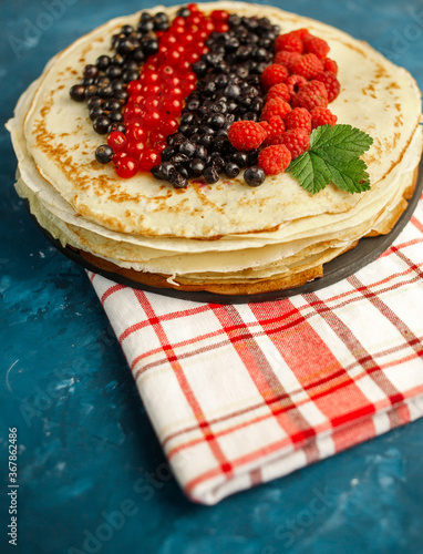 Pancakes with berries. Breakfast. Sweet homemade stack of pancakes
