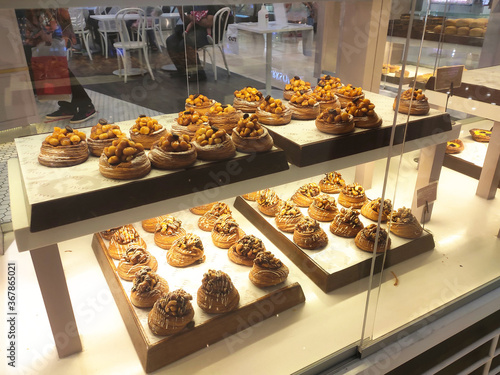 KUALA LUMPUR, MALAYSIA -JULY 17, 2020: Various types of breads are displayed for sale inside the bakery display rack. Made in various designs to provide variations to customers.