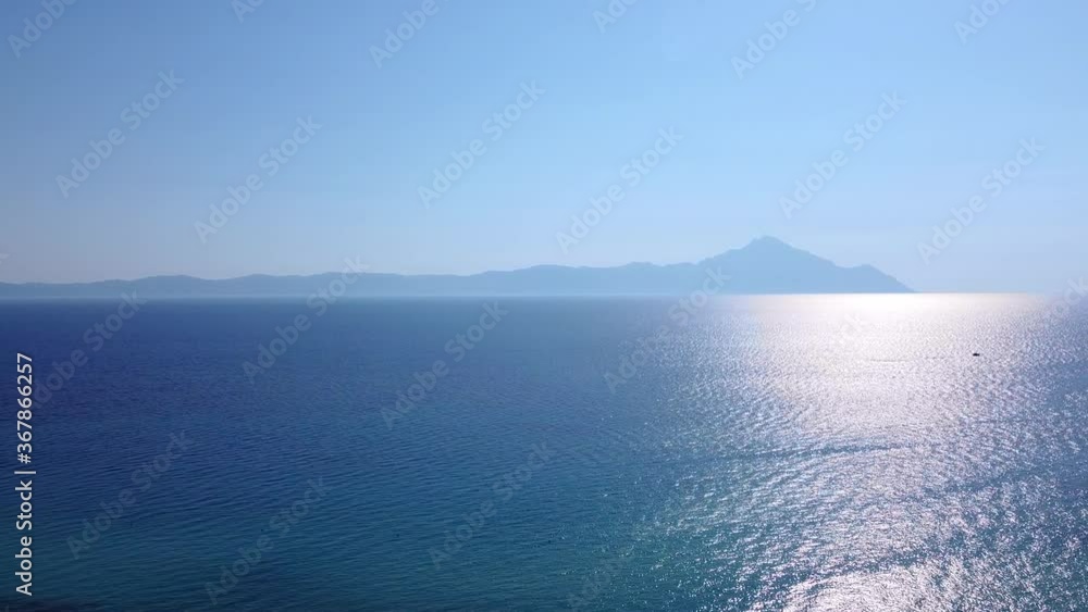 Beautiful Aegean sea in summer morning with view to Athos mount. Aerial view Beautiful Aegean sea in summer morning with view to Athos mount. Aerial view