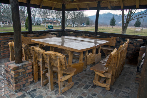 Wooden benches and tables in the outdoor restaurant