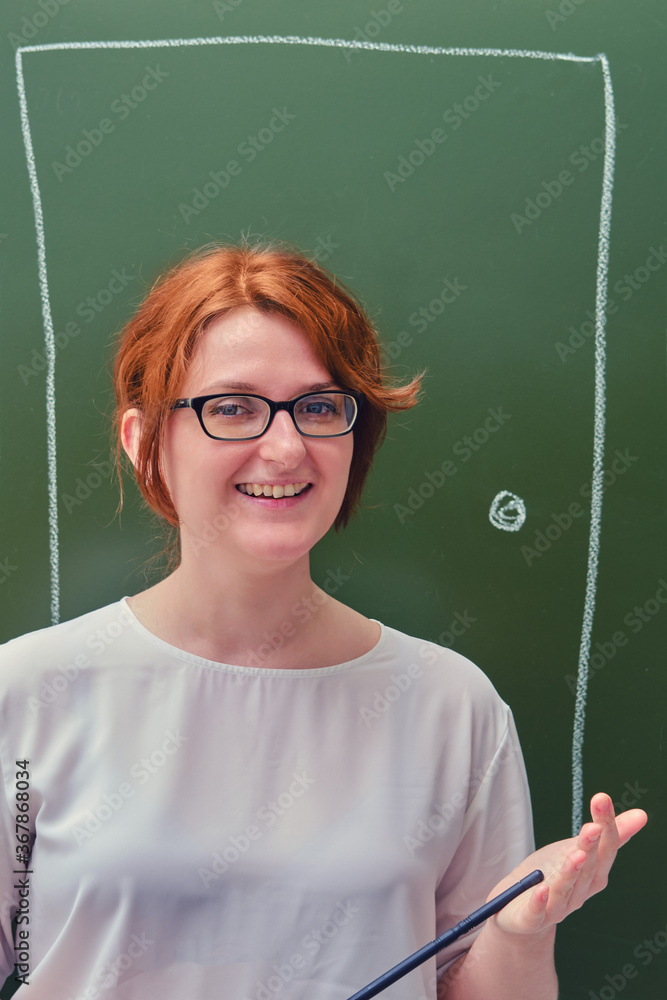 Happy woman teacher on green background. Door drawn in chalk on a blackboard. Concept welcome back to school Happy woman teacher on green background. Door drawn in chalk on a blackboard. Concept welcome back to school