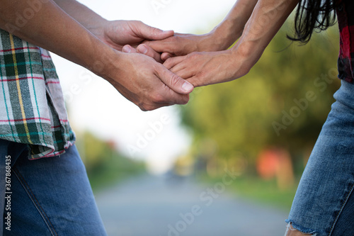 love and relationships concept - closeup of woman and man holding hands 