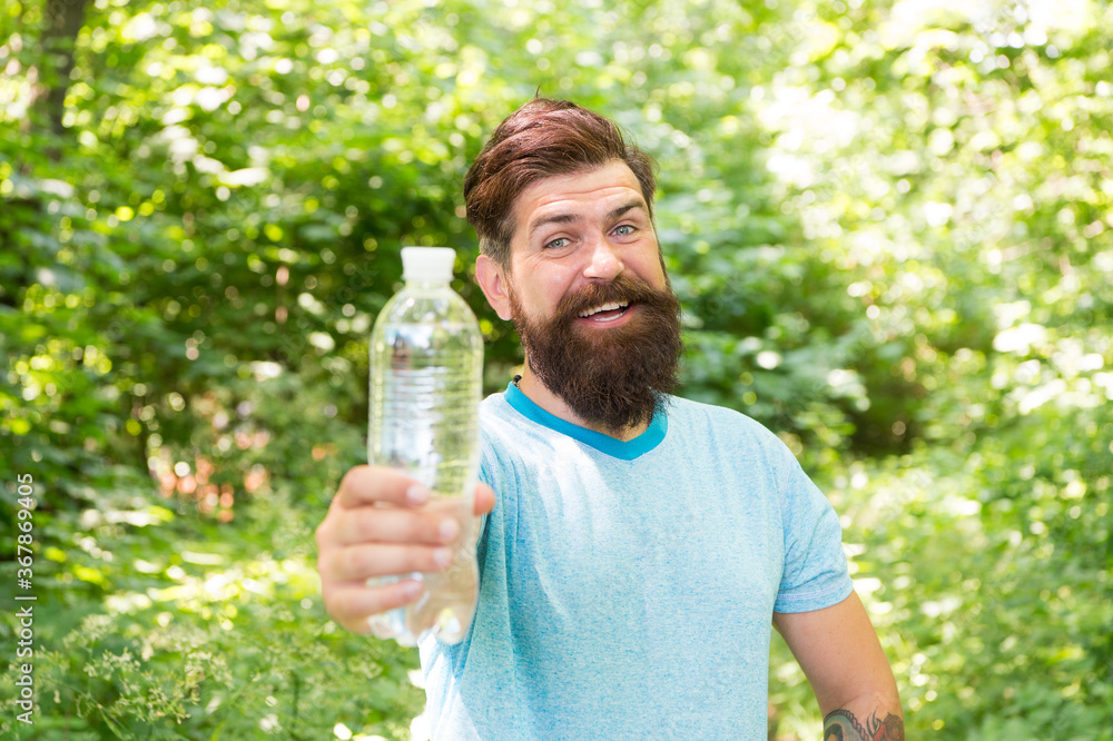 Drink Plenty Of Water. drinking water in forest outdoor with sunset nature on background. Bearded man with water bottle. fitness portrait of bearded man. happy mature guy. thirsty hipster traveler Drink Plenty Of Water. drinking water in forest outdoor with sunset nature on background. Bearded man with water bottle. fitness portrait of bearded man. happy mature guy. thirsty hipster traveler