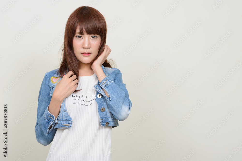 Portrait of young beautiful Asian woman wearing wig Portrait of young beautiful Asian woman wearing wig