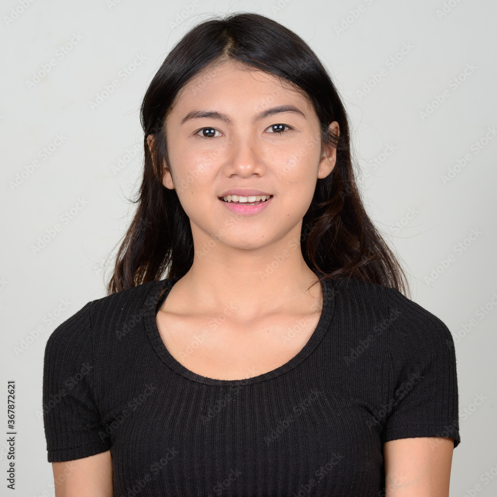 Portrait of happy young beautiful Asian woman smiling Portrait of happy young beautiful Asian woman smiling