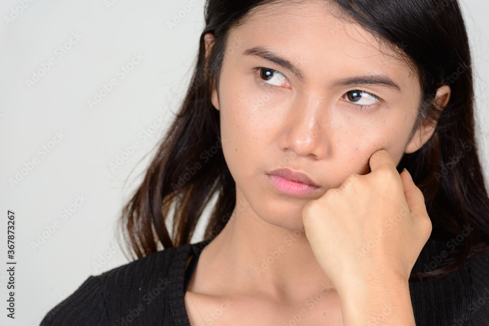 Portrait of young beautiful Asian woman thinking Portrait of young beautiful Asian woman thinking