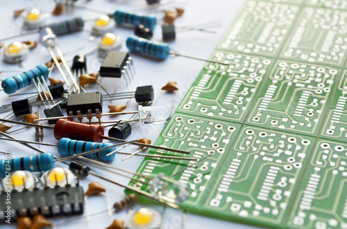 Different electronic components and green electronic circuit board close-up. Shallow depth of field, selective focus photo