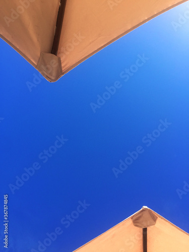 canvas umbrella on blue sky background