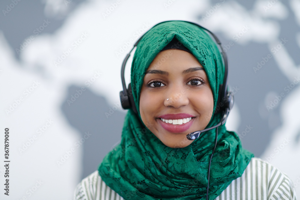 African muslim female with phone headset helping and supporting online African muslim female with phone headset helping and supporting online