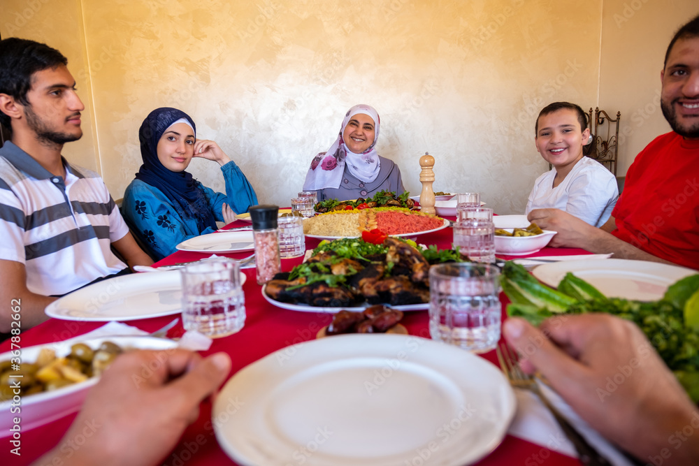 Happy arabic muslim family eating together in a family meeting Happy arabic muslim family eating together in a family meeting