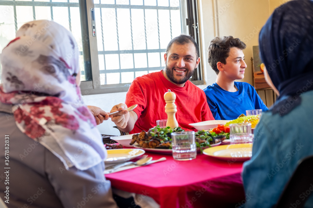 Arabic muslim family eating together in a meeting for iftar in ramadan