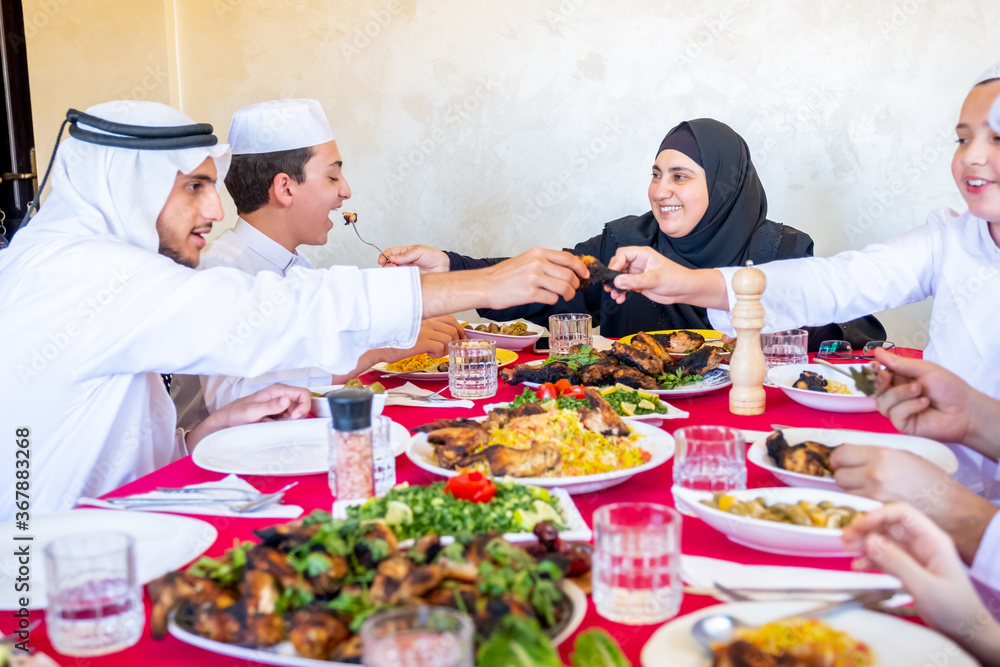 Arabic muslim family eating together in a meeting for iftar in ramdan