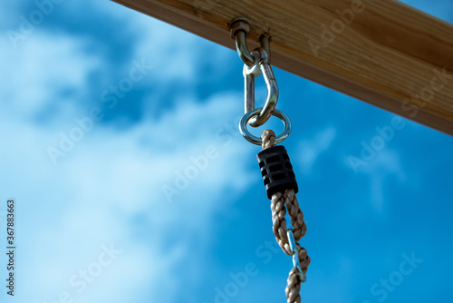 Eye-loop screw mount on bottom of wooden beam