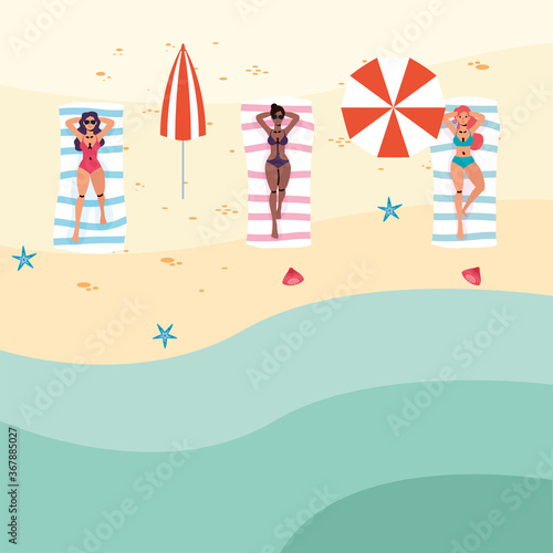 interracial women on the beach practicing social distance