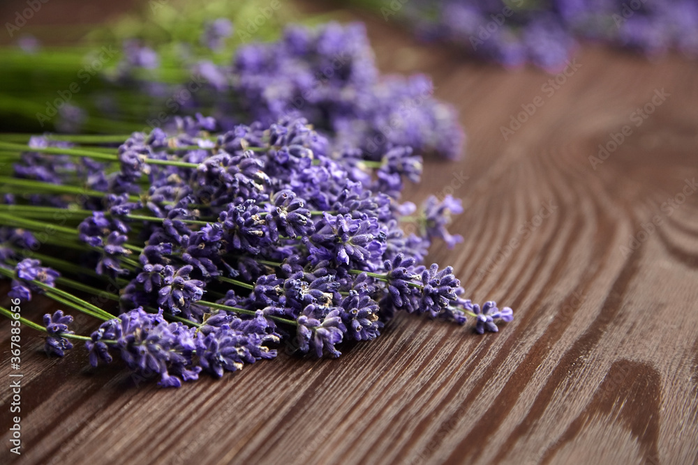 Fototapeta premium Romantic lavender flowers bouquet on wooden background