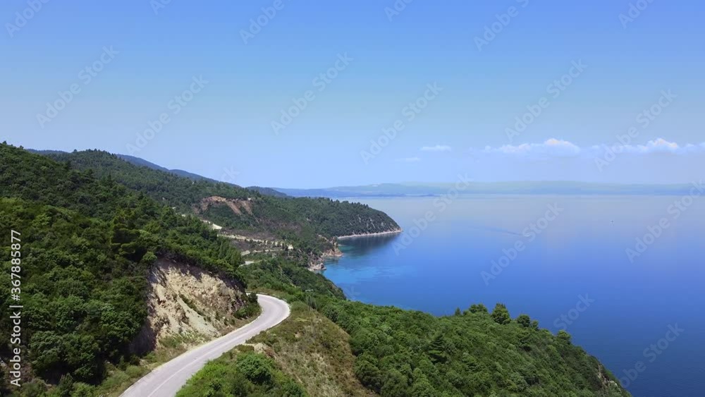 Aerial view of traffic road on the hill and blue sea. Travel vacation concept Aerial view of traffic road on the hill and blue sea. Travel vacation concept