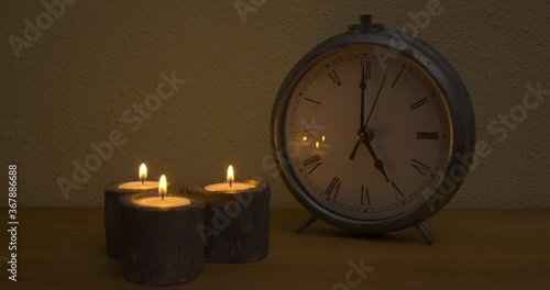 Wallpaper Mural Five o'clock at night, orange flames from three candles, white wall background Torontodigital.ca