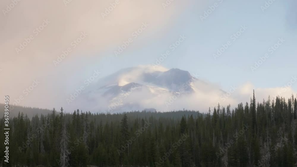 sunrise time lapse of south sister snow covered mountain clouds moving quickly covering peak cascade green forest trees central bend oregon pacific northwest usa sunrise time lapse of south sister snow covered mountain clouds moving quickly covering peak cascade green forest trees central bend oregon pacific northwest usa