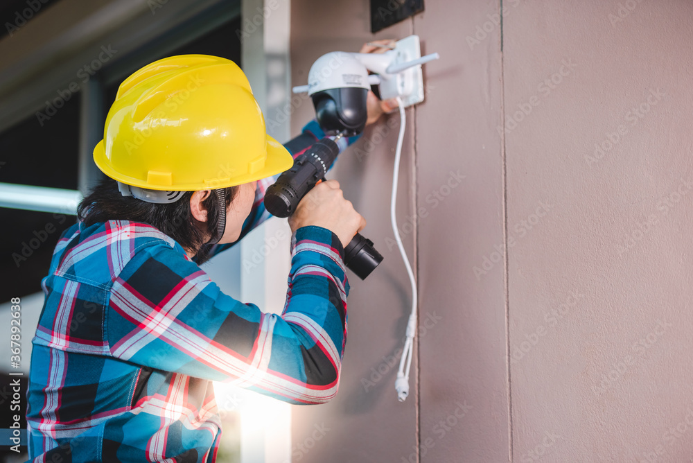 CCTV installation with young Asian technicians. Installation such as Wifi ip camera Concept: wireless IP camera CCTV installation with young Asian technicians. Installation such as Wifi ip camera Concept: wireless IP camera