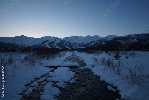 Morning landscape of snowed mountains and river in Japan, Hakuba