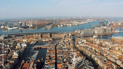 Scenic Landscape Of Amsterdam City From Above Under The Bright Blue Sky. Amsterdam, Netherlands, Europe. - aerial drone photo