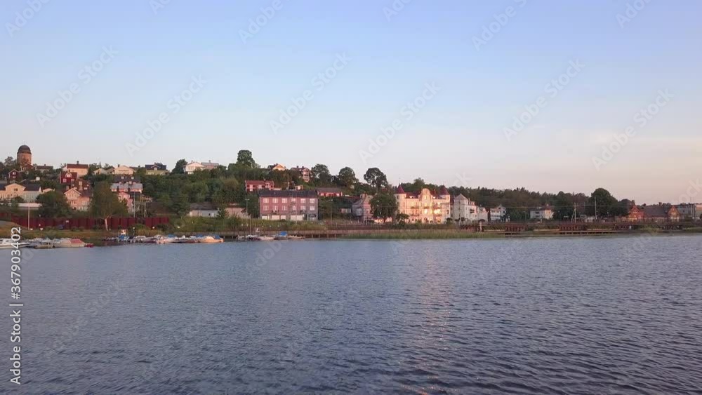 Country side lake town drone low to the ground flyover at evening golden hour time Country side lake town drone low to the ground flyover at evening golden hour time