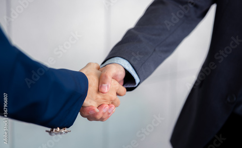 Business people shaking hand together in the office.