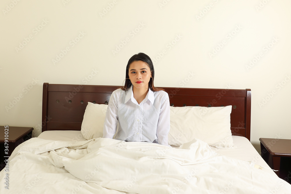 Young beautiful modern Malay woman relax morning wake up on bed look at camera Young beautiful modern Malay woman relax morning wake up on bed look at camera