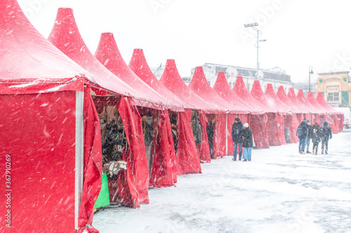 Christmas tents at the downtown fairground during a blizzard