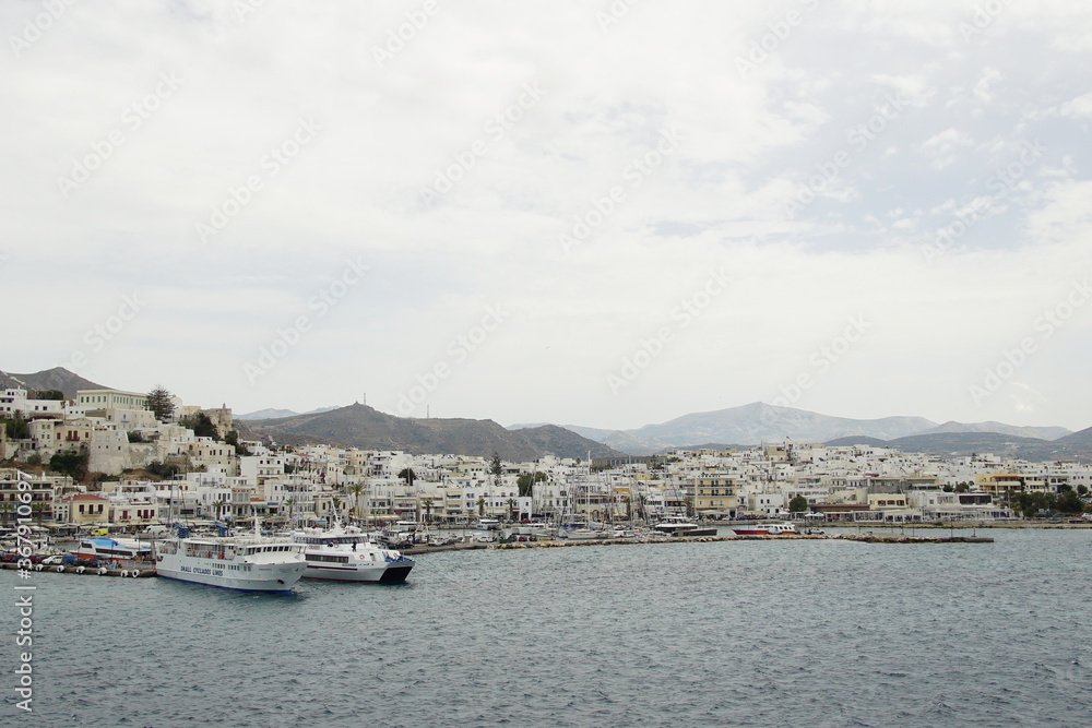 the ferry arriving at white buildings island, Greece, Europe
