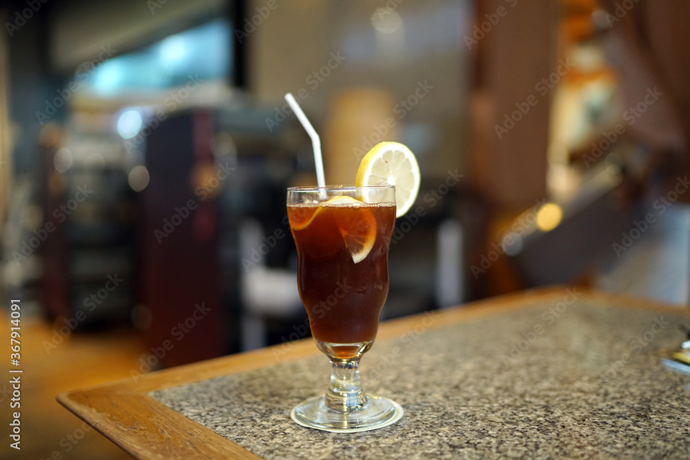 A glass of Iced lemon tea on table and blurred background, Summer Cocktail or Tropical Mocktail, Healthy drink concept. A glass of Iced lemon tea on table and blurred background, Summer Cocktail or Tropical Mocktail, Healthy drink concept.