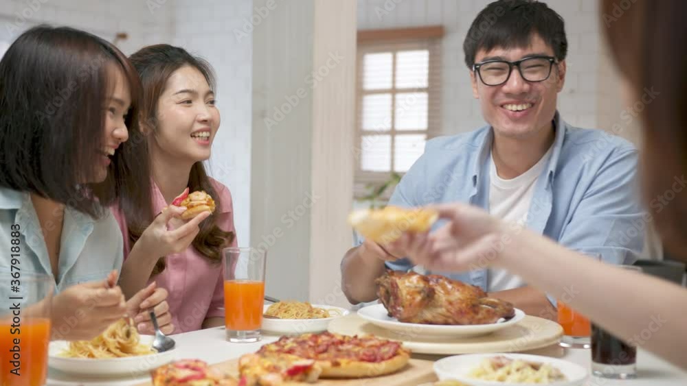 Point of view (POV) happy asian friend eating pizza at home. Group friend cheerful mates laughing enjoying meal having fun sitting together at home dining table, diverse friends share lunch at meeting Point of view (POV) happy asian friend eating pizza at home. Group friend cheerful mates laughing enjoying meal having fun sitting together at home dining table, diverse friends share lunch at meeting