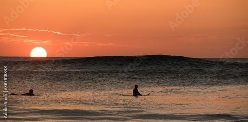 Surfer in front of sunset at Playa Grande Costa Rica
