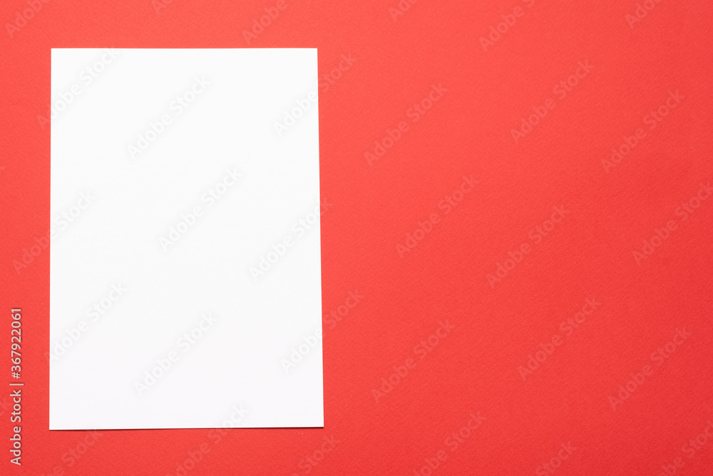 Blank paper page with copy space on the red flat lay background. Blank paper page with copy space on the red flat lay background.