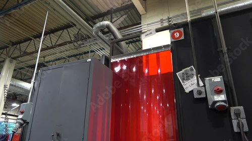 Wide shot of arc flashes coming from a welding booth. photo