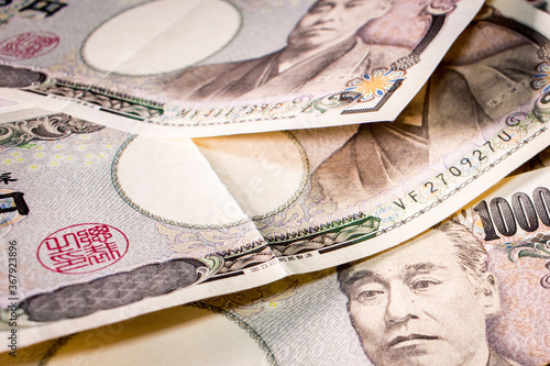 Close up of a couple of  Japanese 10000 yen banknotes on table. photo