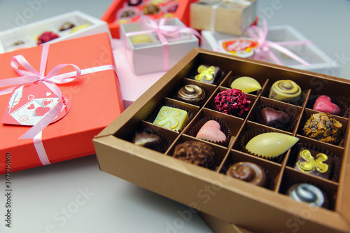 Handmade chocolates in holiday boxes. Assorted chocolates in boxes on the table. © IvSky