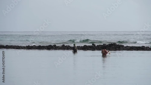 Locals look for fish in fish pond in Molokai, Hawaii. Ancient tradition. 