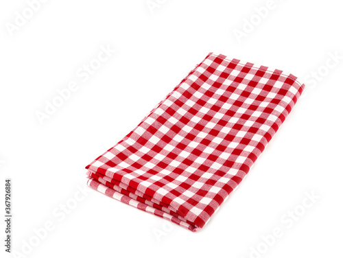 Closeup of red and white checkered fabric or napkin isolated on white background. Concept kitchen utensils and tableware..
