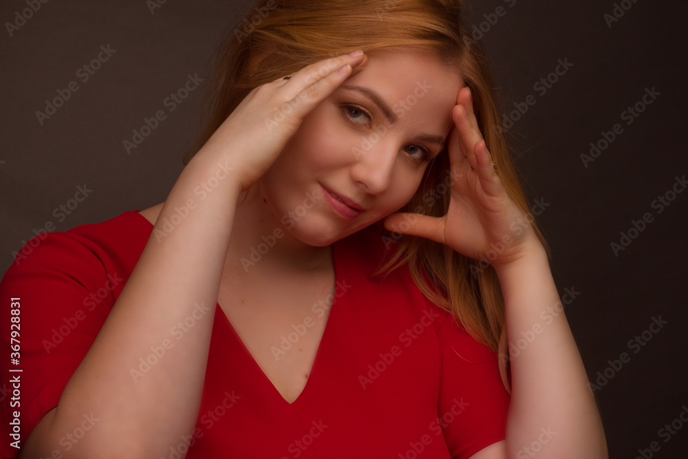 Obraz premium Studio portrait of an overweight young woman with light hair on a black background