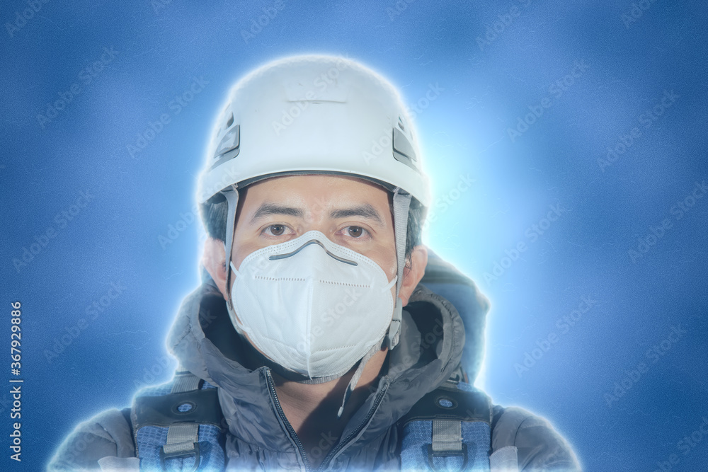full length portrait of hiker with mask and helmet on blue background full length portrait of hiker with mask and helmet on blue background