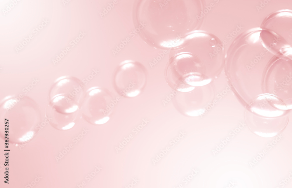 Beautiful blurry clear pink soap bubbles float background 