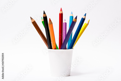 Various color pencils in white cup isolated on the white background 