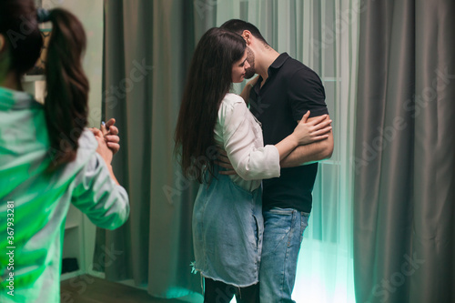 Cheerful young couple having a good time dancing at a party.