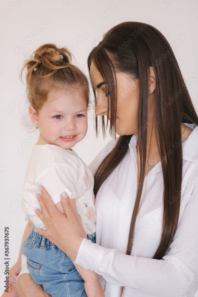Portrait of Little girl with mom in studio. White background Portrait of Little girl with mom in studio. White background