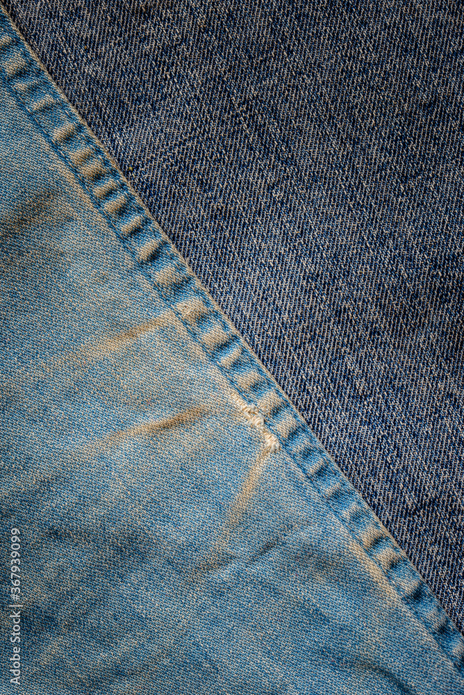 Detail of blue jeans texture with yellow stain. Free room for copyspace. Detail of blue jeans texture with yellow stain. Free room for copyspace.