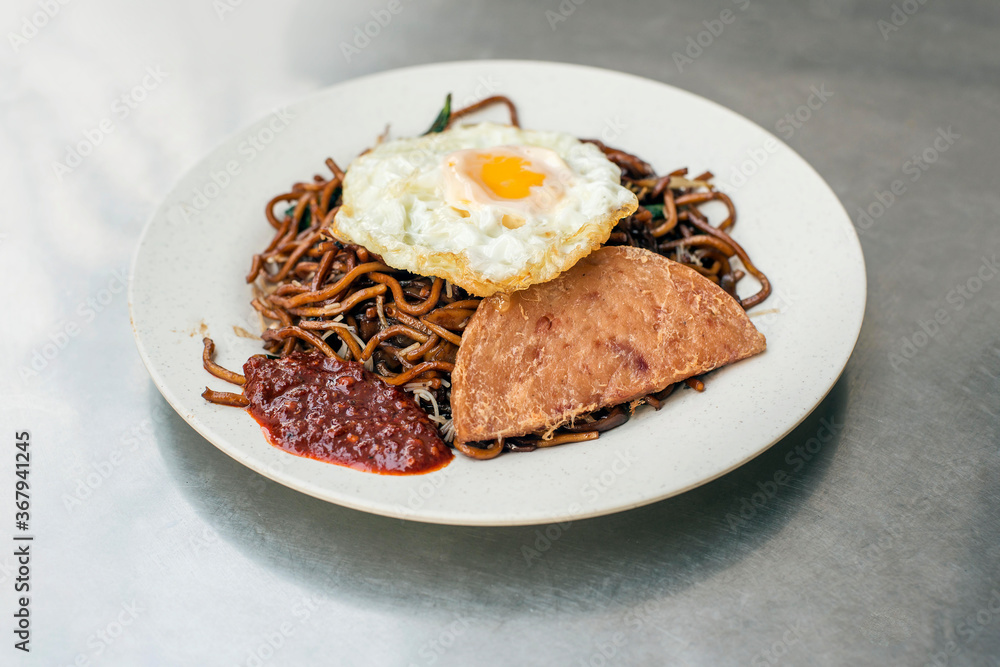 Singapore fried noodles with luncheon meat and a fried egg Singapore fried noodles with luncheon meat and a fried egg