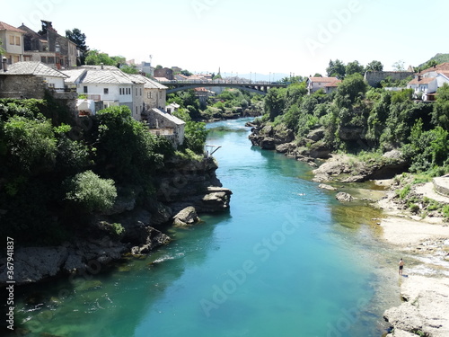 People is diving from a springboard into Neretva River in Mostar old town. Mostar is a city and the administrative center of?Herzegovina-Neretva Canton?of the?Federation of Bosnia and Herzegovina.