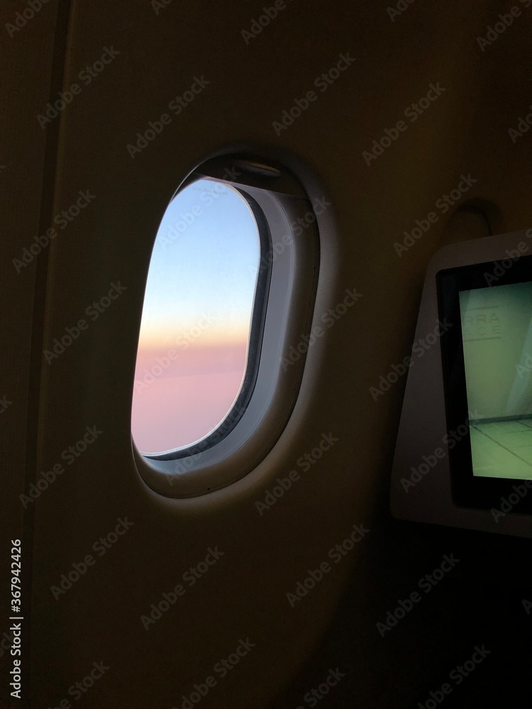 Photo of a sunset taken onboard the business class of commercial flight. Photo of a sunset taken onboard the business class of commercial flight.