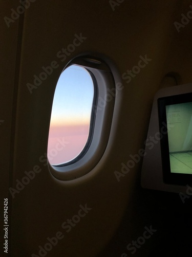 Photo of a sunset taken onboard the business class of commercial flight.